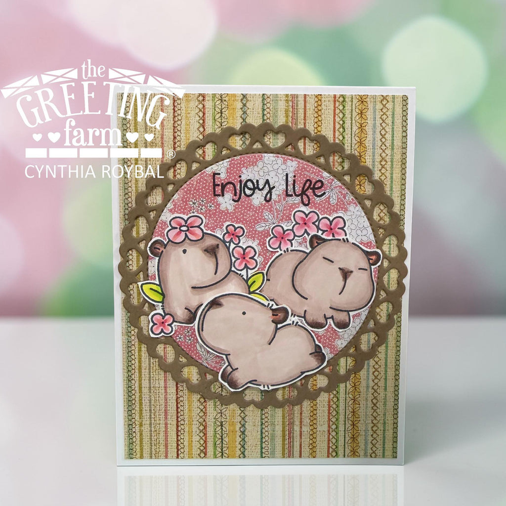 Card with capybara design and 'Enjoy Life' text on a striped background, branded by The Greeting Farm | color-code:ALT02