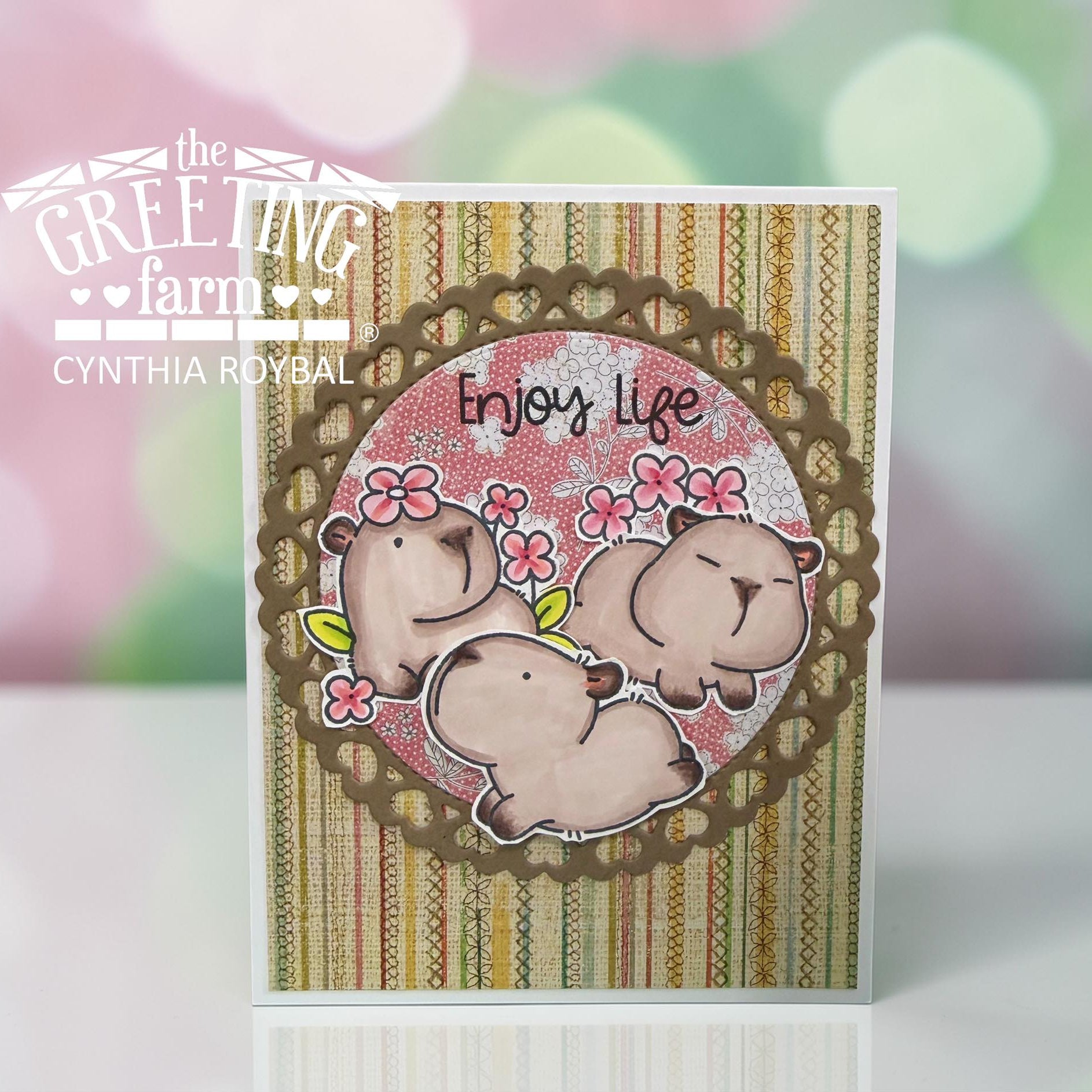 Card with capybara design and 'Enjoy Life' text on a striped background, branded by The Greeting Farm | color-code:ALT02