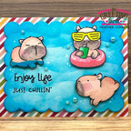 Card with capybaras enjoying life in a pool, featuring 'Enjoy Life Just Chillin' text.