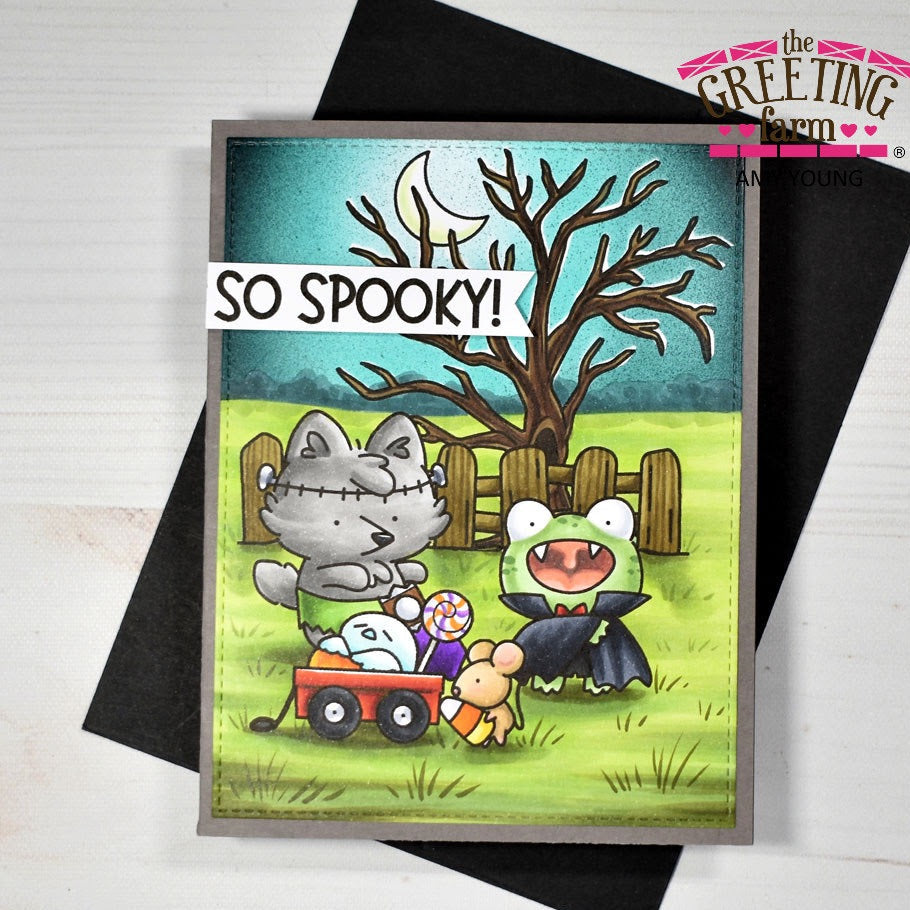 Halloween-themed card with cartoon animals in costumes on a wooden surface, featuring 'The Greeting Farm' branding.