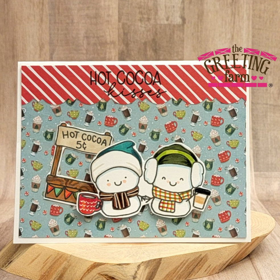 Card with cartoon snowmen holding hot cocoa and candy canes on a wooden surface, featuring 'The Greeting Farm' branding | color-code:ALT02