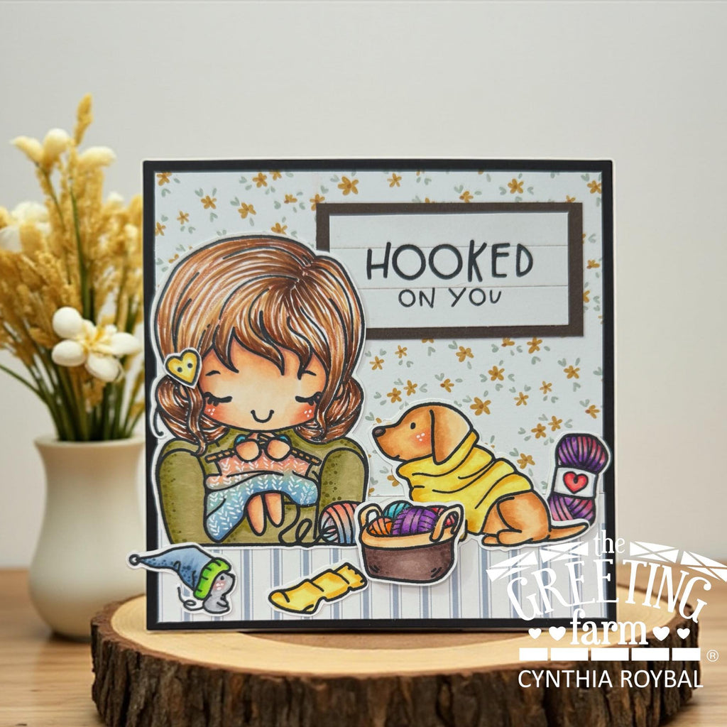 Card with illustration of a girl and dog with yarn, text 'Hooked on You', and 'The Greeting Farm' branding | color-code:ALT02