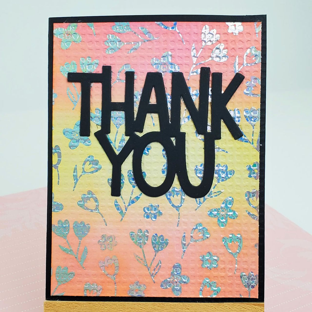 Card with 'THANK YOU' text on a floral patterned background