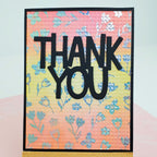 Card with 'THANK YOU' text on a floral patterned background