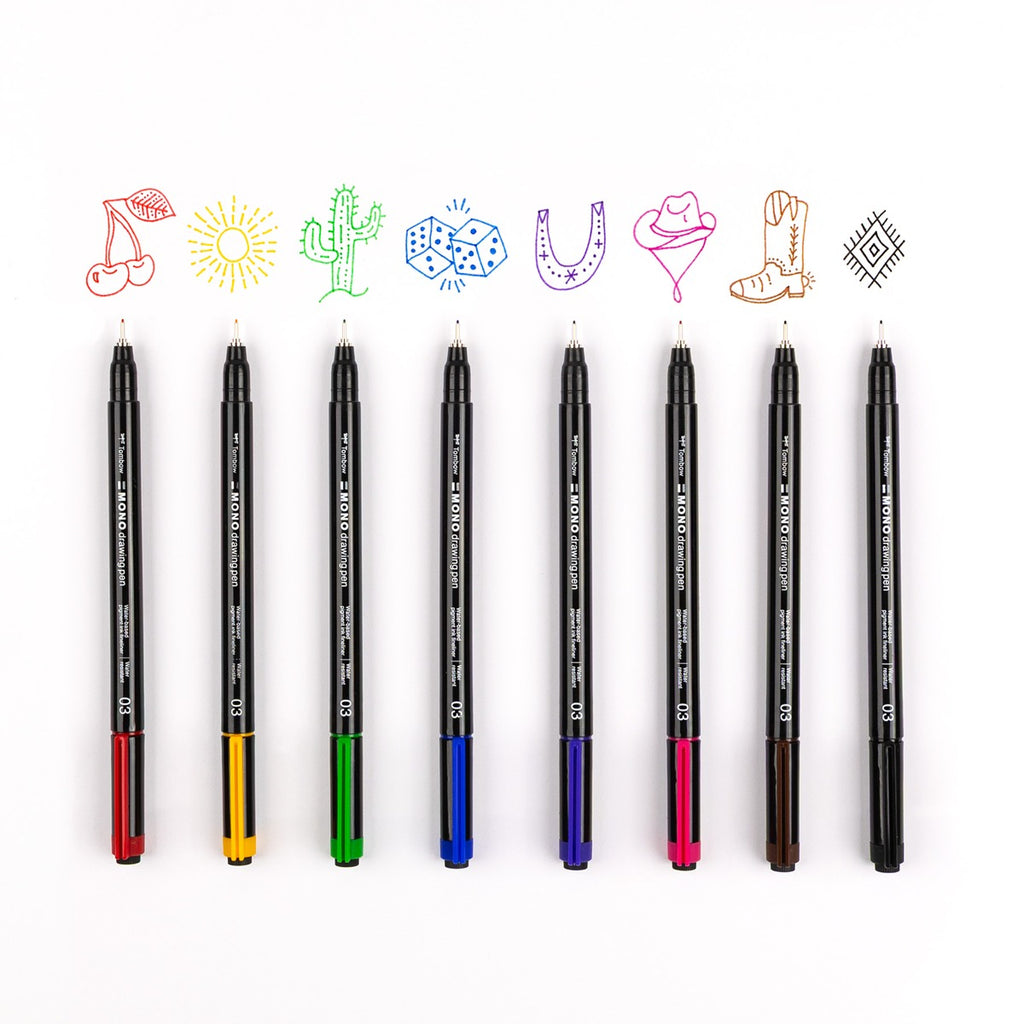 Tombow Mono Drawing Pens Colors 8-Pack 66407 shown with lids off to show pen tip and doodles