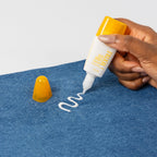 Tombow Mono Textile Liquid Glue 62185 shown applying to denim