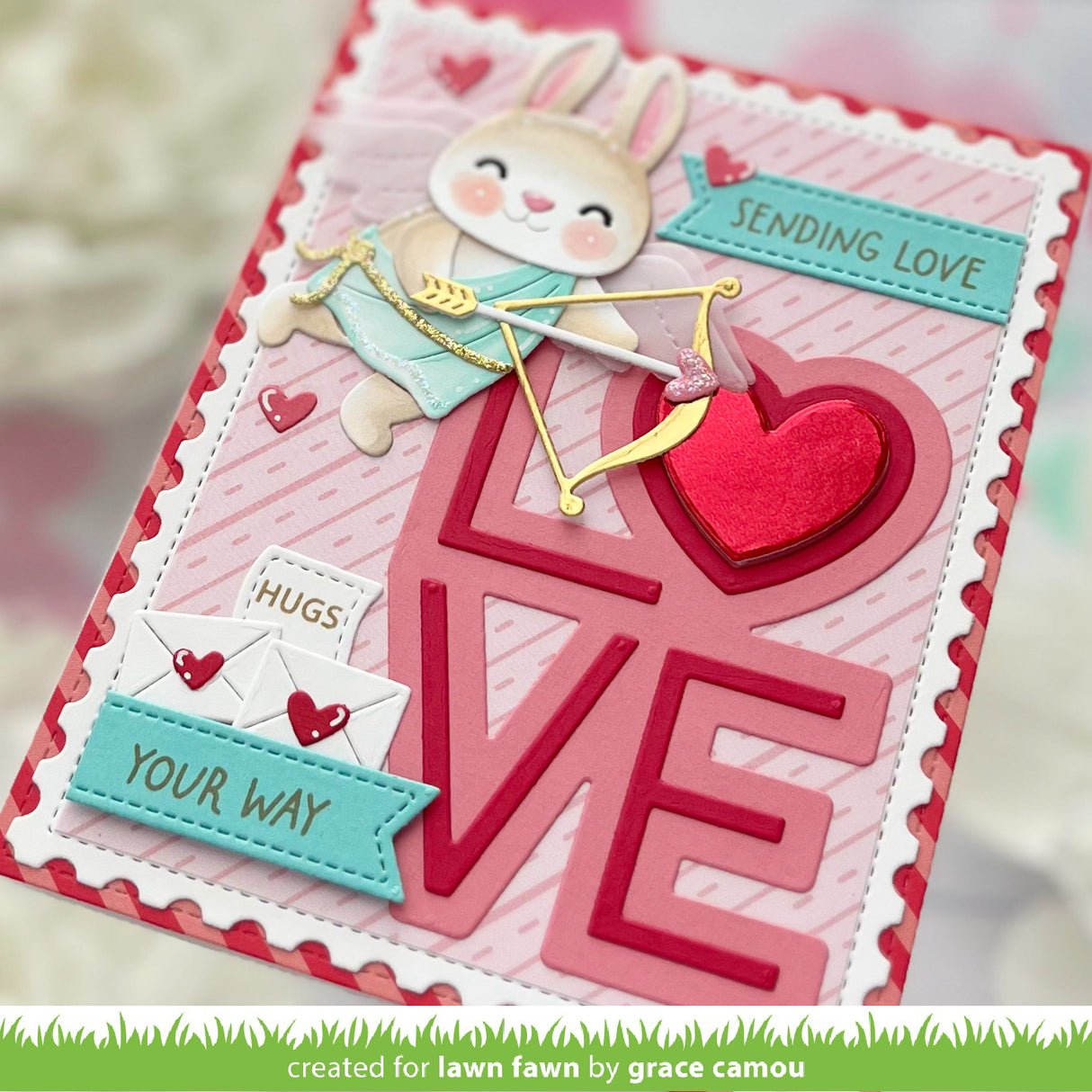 Valentine's Day card with a bunny, heart, and 'LOVE' text on a pink background.