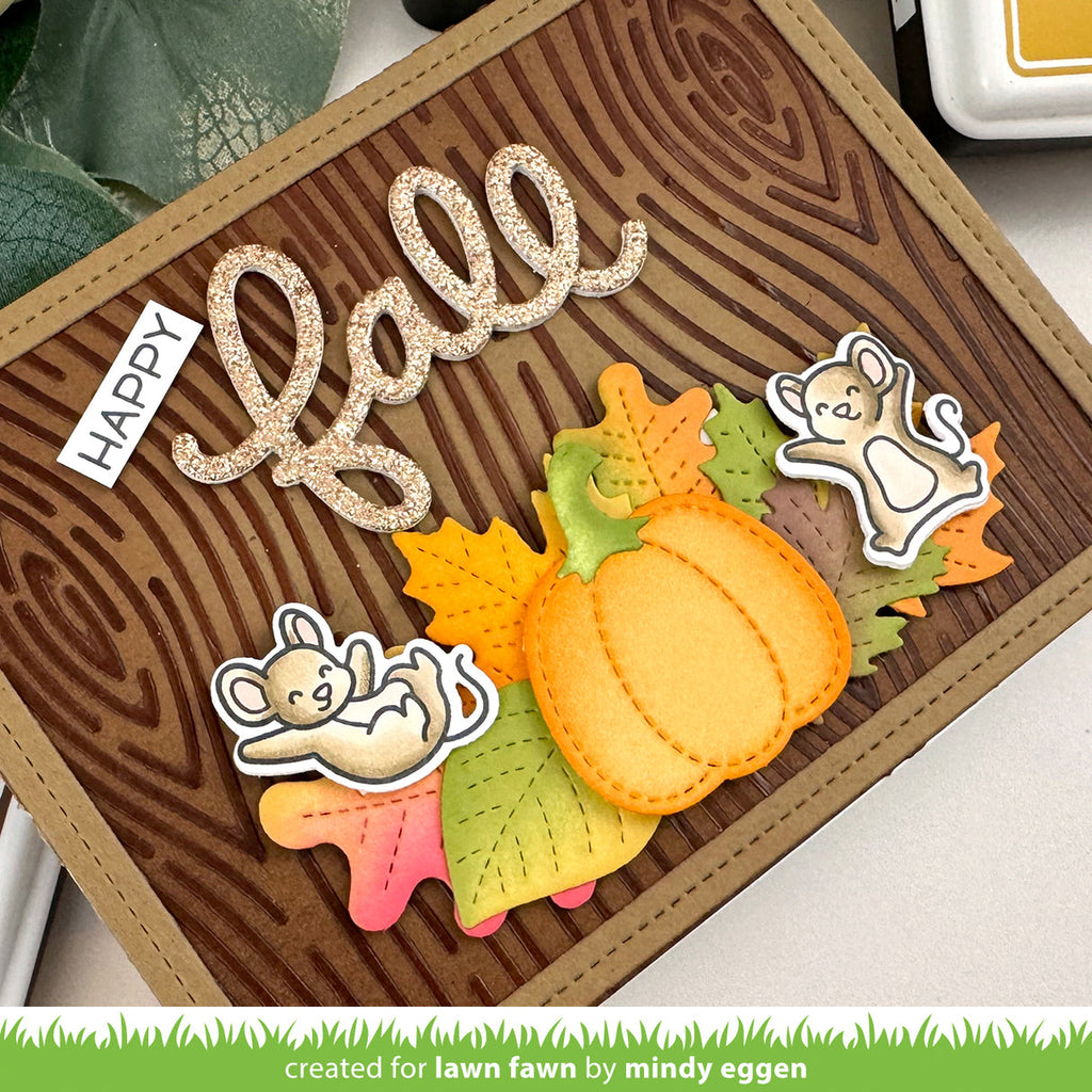Autumn-themed card with pumpkins, leaves, and 'Happy Fall' text on a wooden background.